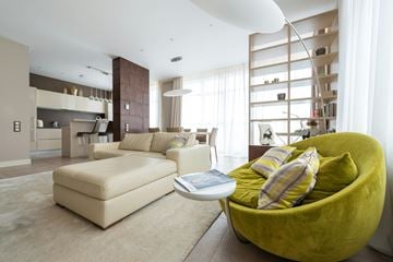 San Francisco apartment for rent - A modern living room with a green chair and a white couch.