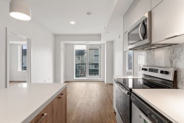 Stittsville apartment for rent - A modern kitchen with a stainless steel oven and microwave.