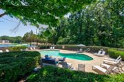 College Park apartment for rent - a pool with chairs and chairs around it and a swimming pool
