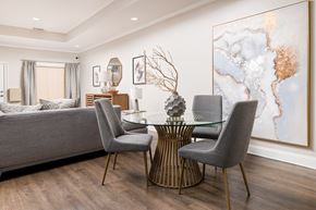 Atlanta apartment for rent - A modern dining room with a glass table and grey chairs.