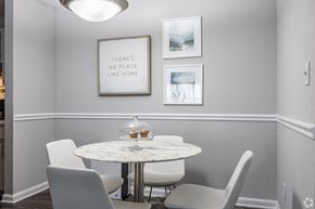 Ellenwood apartment for rent - a dining room with a marble table and white chairs
