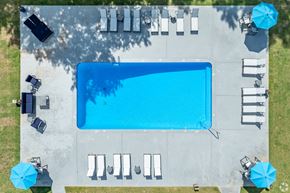 Ellenwood apartment for rent - an aerial view of a pool with umbrellas and tables and chairs around it
