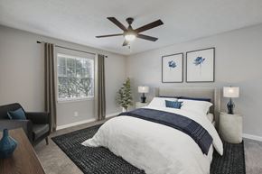 Atlanta apartment for rent - A bedroom with a large bed and a ceiling fan.