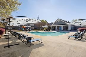 Atlanta apartment for rent - A pool area with sun loungers and a building in the background.
