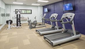 Muskegon apartment for rent - A gym with treadmills, elliptical machines, and other exercise equipment.