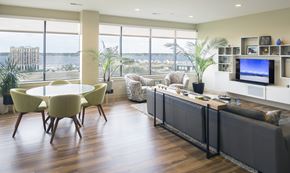Muskegon apartment for rent - A living room with a large window overlooking the water.