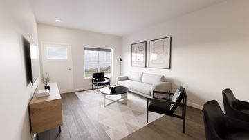 Appleton apartment for rent - A living room with a grey sofa, a black chair and a wooden side table.