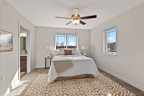 Deforest townhouse for rent - a bedroom with a bed and a ceiling fan at The Residences Apartments at Bear Tree, DeForest, Wisconsin