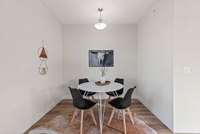 Deforest townhouse for rent - a dining room with a white table and chairs at The Residences Apartments at Bear Tree, DeForest, WI, 53532