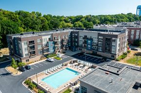Wauwatosa apartment for rent - A large apartment complex with a pool and a parking lot.