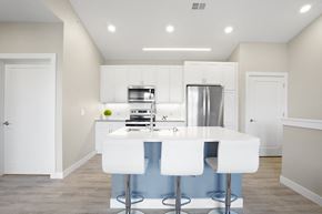 Oconomowoc apartment for rent - a kitchen with white cabinets and a white counter top and a stainless steel refrigerator