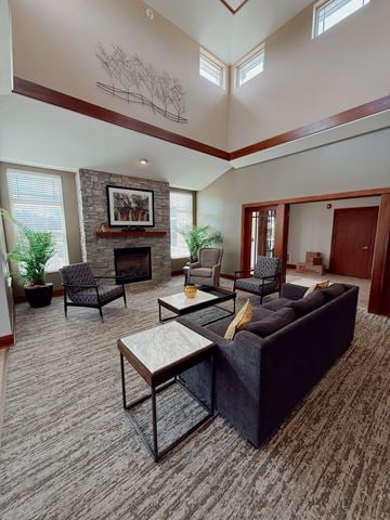 Oconomowoc apartment for rent - A living room with a stone fireplace and a painting above it.