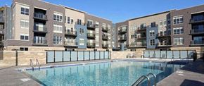 Wauwatosa apartment for rent - a large swimming pool in front of an apartment building