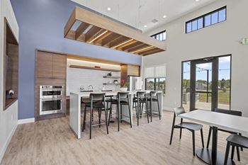 A kitchen and dining area with a table and chairs