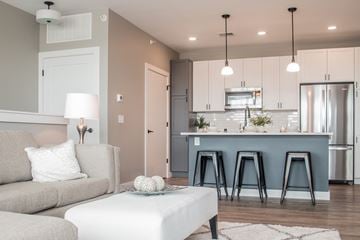 Mount Pleasant townhouse for rent - a living room with a couch and a kitchen with a blue counter