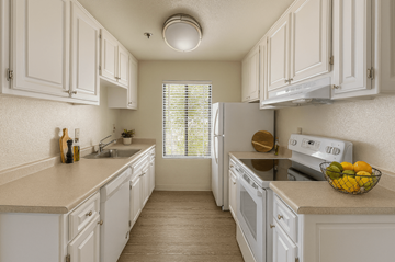 Rohnert Park apartment for rent - A kitchen with white cabinets and appliances.