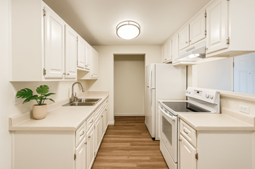 Rohnert Park apartment for rent - A kitchen with white cabinets and appliances.