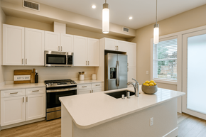 Rohnert Park apartment for rent - A kitchen with white cabinets and a large island.at Edgeway Plaza, Rohnert Park, 94928