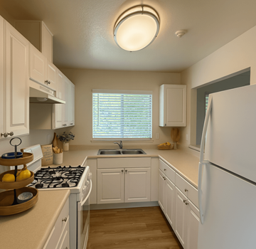 Rohnert Park apartment for rent - A kitchen with white cabinets and a white refrigerator.
