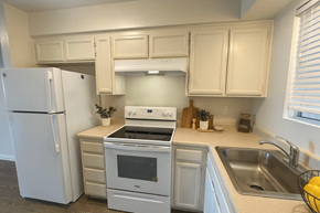 Novato apartment for rent - A kitchen with a white refrigerator and a white oven.at Posada East, Novato, CA 94949