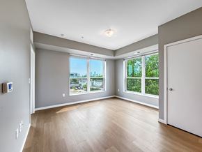 Minneapolis apartment for rent - A spacious room with a view of the city through the windows.
