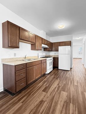 Minneapolis apartment for rent - A kitchen with wooden cabinets and a white refrigerator.