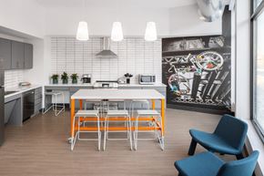 Minneapolis apartment for rent - a kitchen with a white table and orange stools
