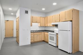 Minneapolis apartment for rent - a kitchen with a white refrigerator freezer next to a stove top oven