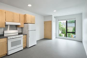 Minneapolis apartment for rent - a kitchen with white appliances and wooden cabinets and a window