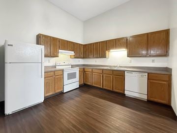 St. Paul apartment for rent - A kitchen with wooden cabinets and white appliances.