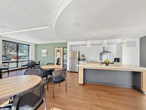 St. Paul apartment for rent - Another view of the Stryker Senior Apartments in West St. Paul Community Room with a wooden table and chairs.