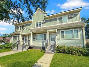 Minneapolis apartment for rent - A two-story house with a green and beige exterior.