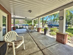 Minnetonka apartment for rent - A white chair is on a porch with a clock on a post.