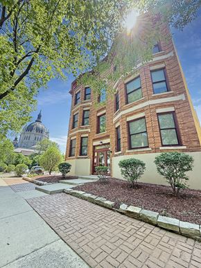 St. Paul apartment for rent - A building with a brick facade and a dome in the background.