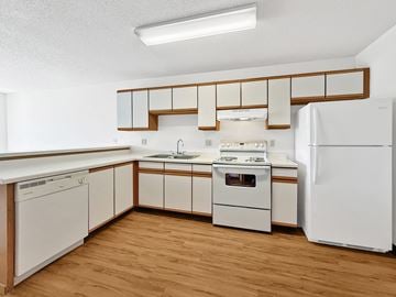 Minnetonka apartment for rent - A kitchen with white appliances and wooden cabinets.