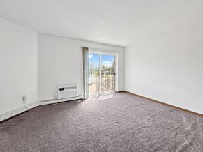 Minnetonka apartment for rent - A room with a carpeted floor, a window, and a door leading to a balcony.