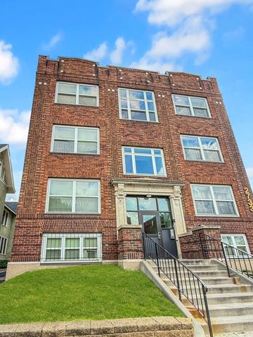 Minneapolis apartment for rent - A red brick building with a black door and windows.
