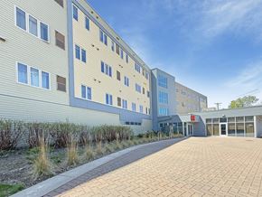 St. Paul apartment for rent - A modern building with a brick walkway in front.