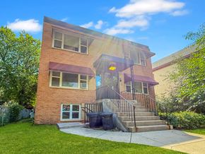 Minneapolis apartment for rent - A house with a red awning and a black trash can in front of it.
