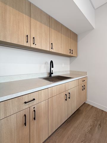 St. Paul apartment for rent - A kitchen with wooden cabinets and a white countertop.