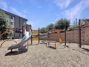 Saint Paul apartment for rent - A playground with a slide, swings, and a climbing frame.