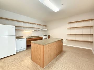 St. Paul apartment for rent - A kitchen with a white refrigerator and a wooden island.