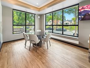 Minneapolis apartment for rent - A dining room with a table and chairs with a view of the street outside.