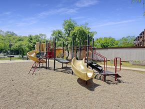 St. Paul apartment for rent - A playground with a yellow slide and red and black equipment.