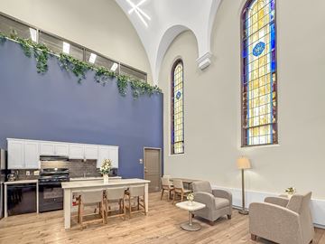 Minneapolis apartment for rent - A kitchen with a table and chairs in front of a stained glass window.