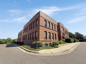 St. Paul apartment for rent - A red brick building with a black fence in front.