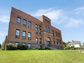 St. Paul apartment for rent - A red brick building with a tower and arched doorway.