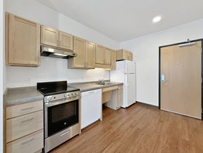 St. Paul apartment for rent - A studio apartment kitchen at Stryker Senior Apartments in West St. Paul with wooden cabinets and stainless steel appliances.
