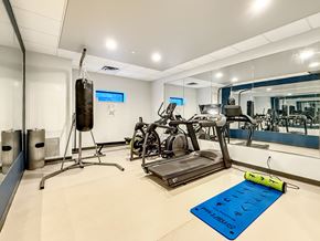 Minneapolis apartment for rent - A gym with a punching bag, treadmill, and exercise bikes.
