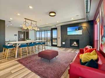 Minneapolis apartment for rent - A modern living room with a red couch and a fireplace.